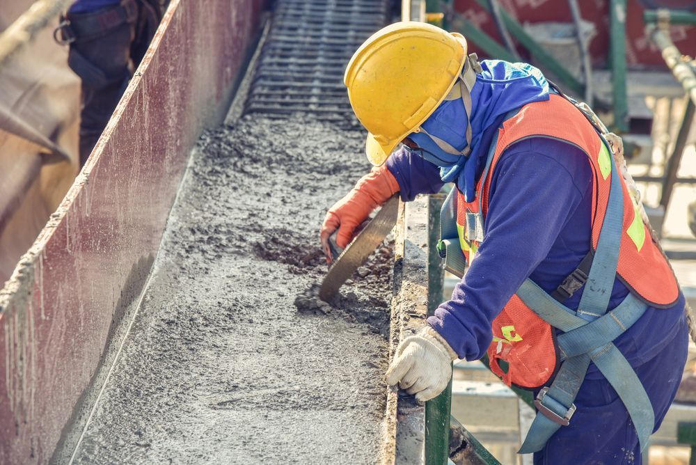A Construction Worker Wearing A Hard Hat And Safety — Northern Rivers Concrete Construction In Tenterfield, NSW