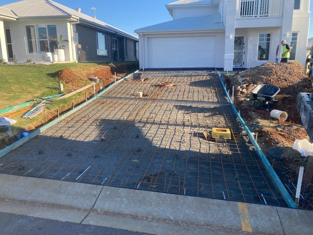 A Concrete Driveway Is Being Built Near The House — Northern Rivers Concrete Construction In Pimlico, NSW