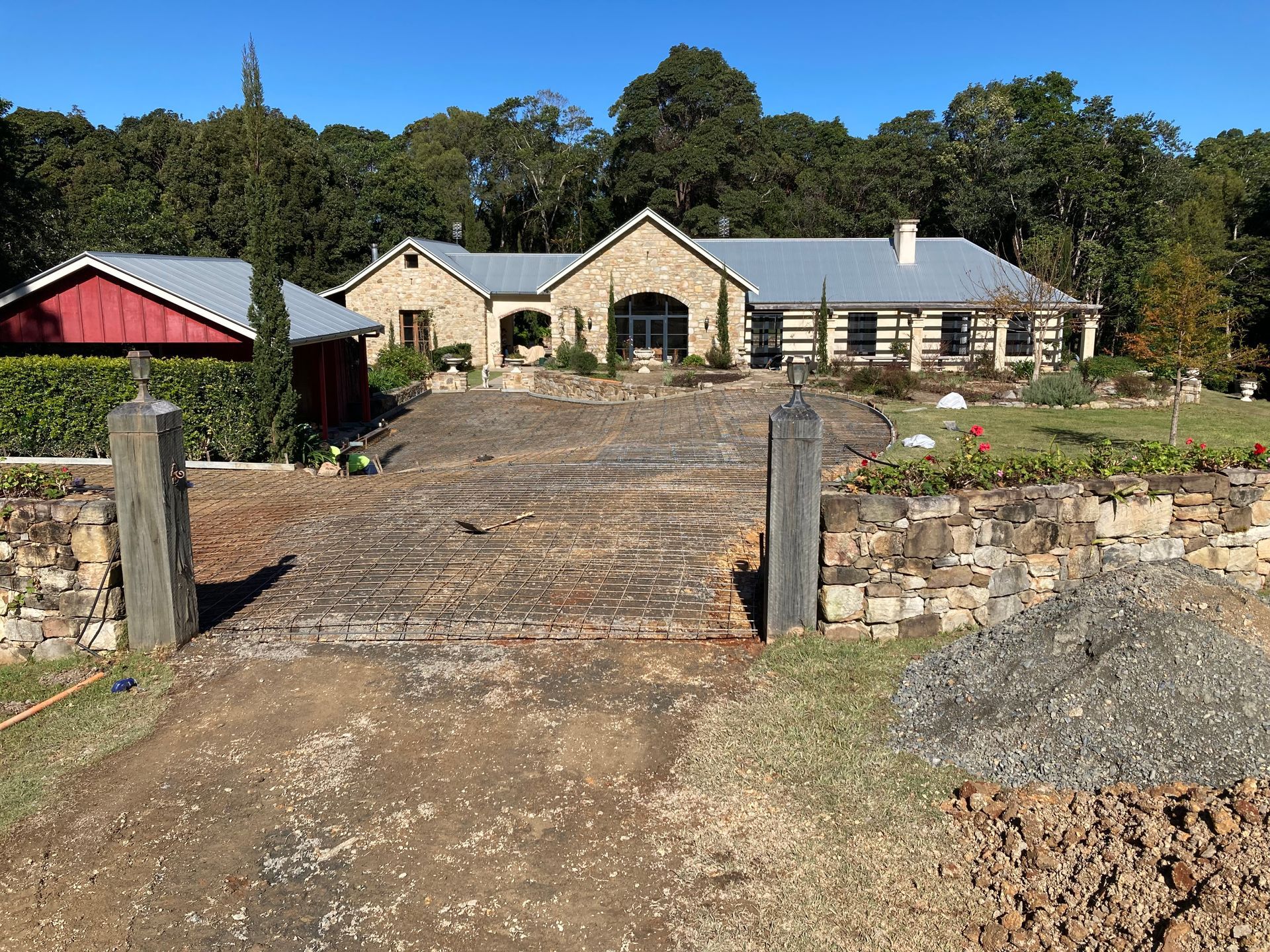 A Large House With A Stone Driveway Leading To It — Northern Rivers Concrete Construction In Pimlico, NSW
