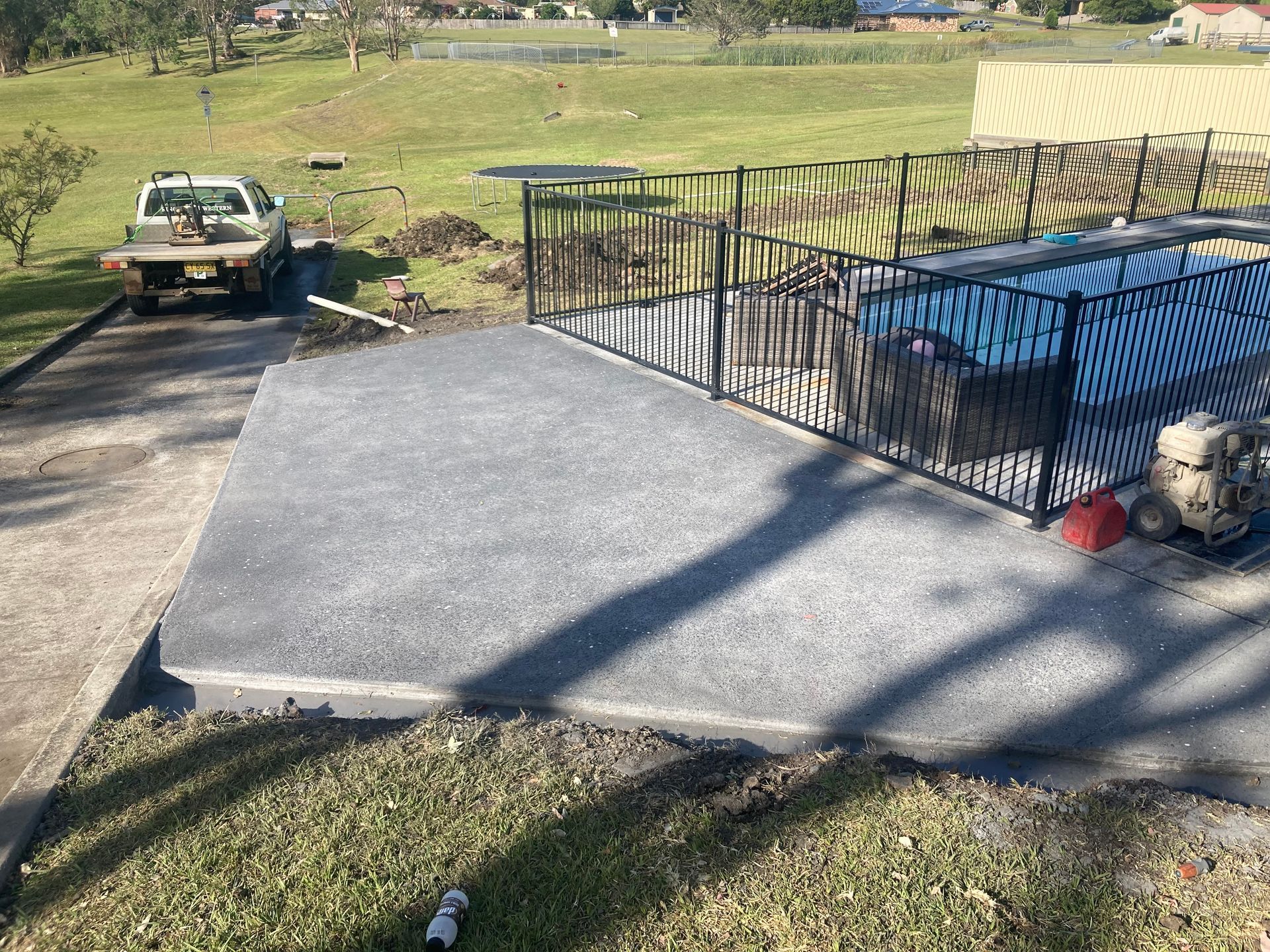 A Concrete Slab Next To A Road With A Truck — Northern Rivers Concrete Construction In Pimlico, NSW