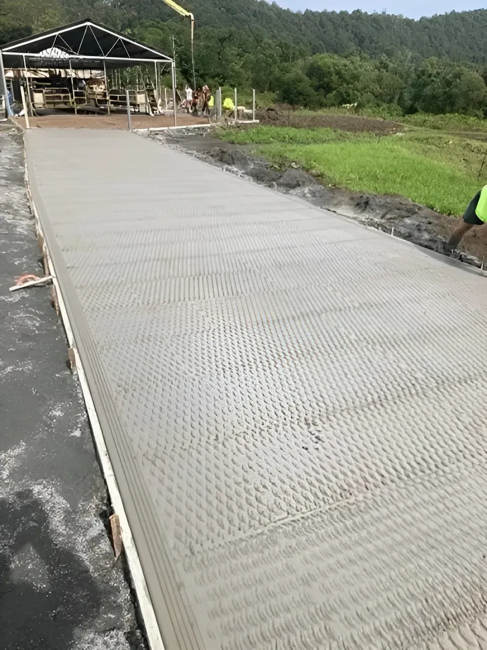A Concrete Road Is Being Built In A Field — Northern Rivers Concrete Construction In Ballina, NSW