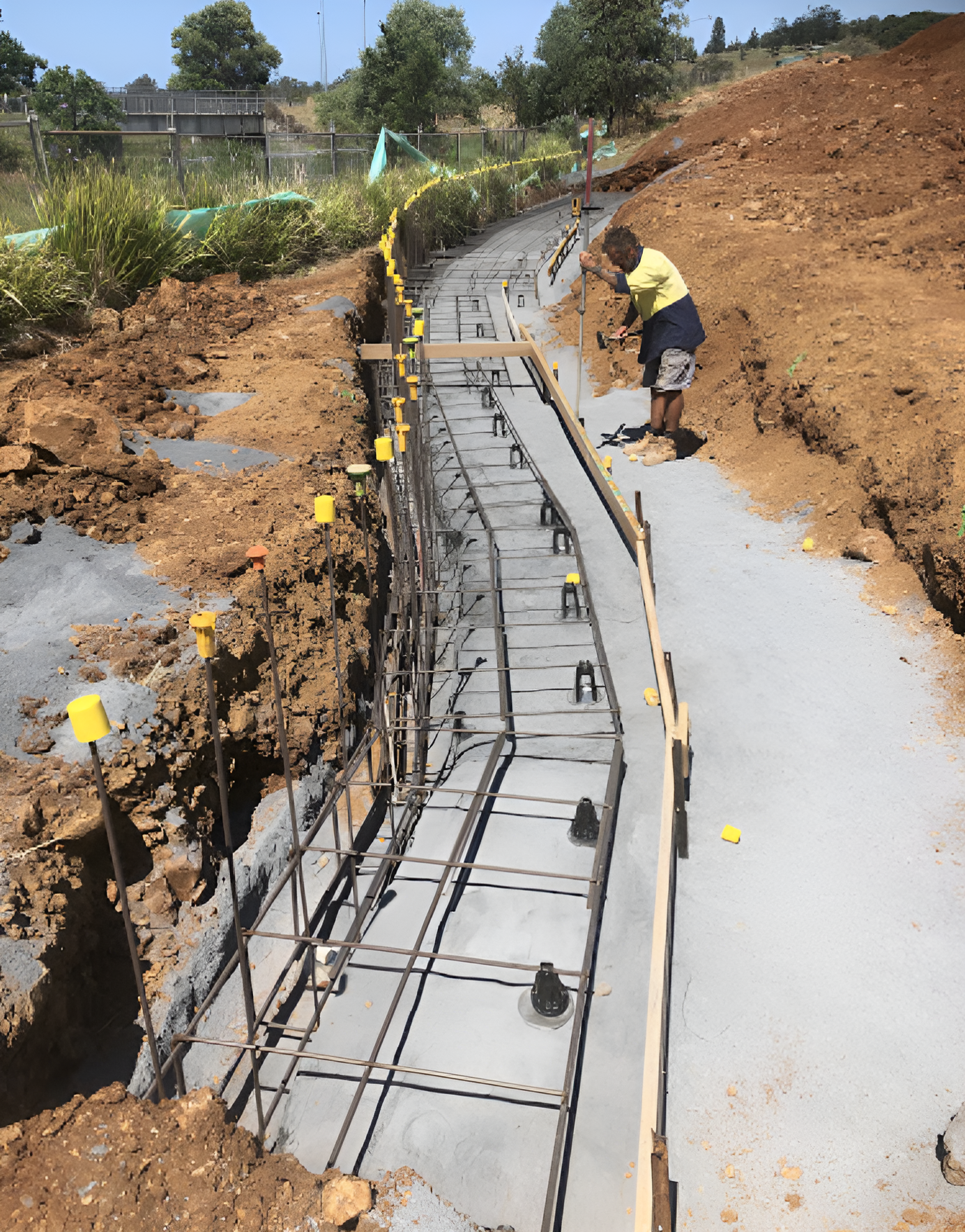 A Man Is Working On A Concrete — Northern Rivers Concrete Construction In Pimlico, NSW