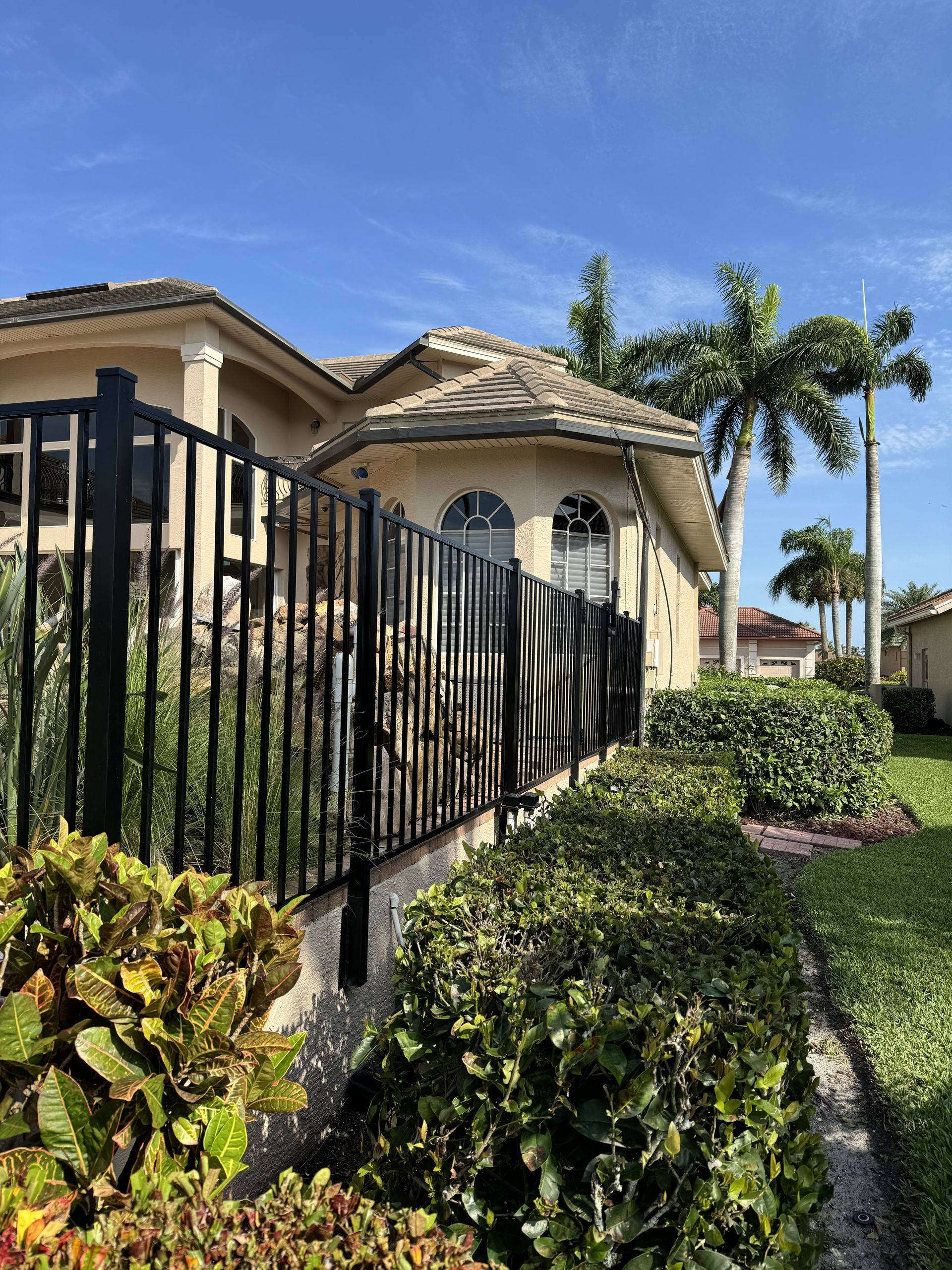 A house with a black fence in front of it.
