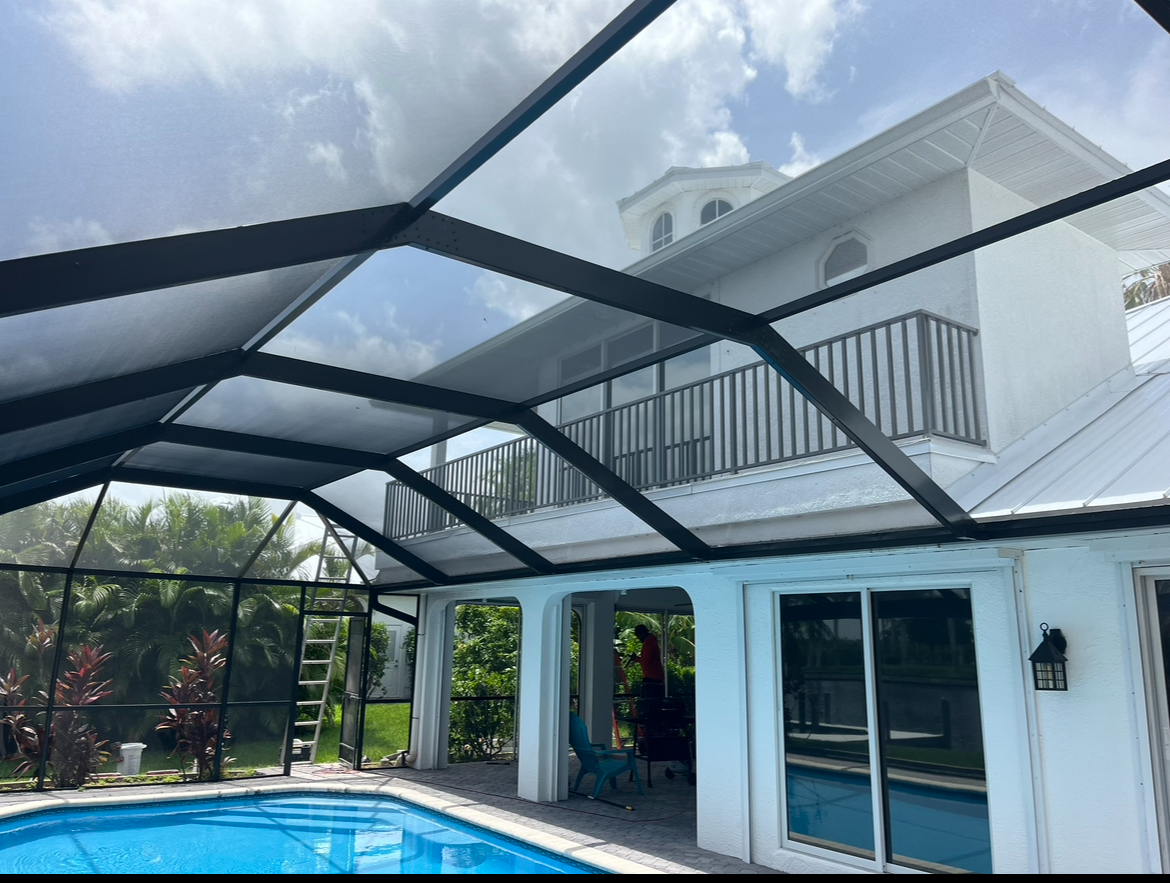 A large house with a swimming pool in front of it