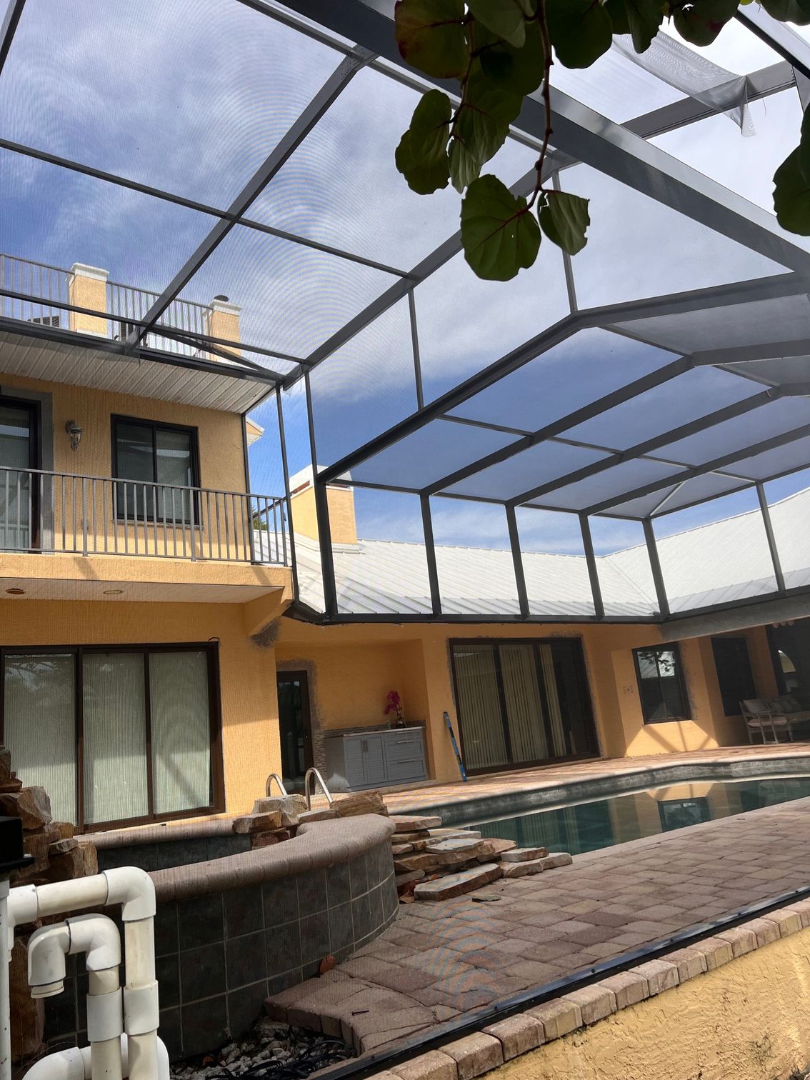 A large house with a swimming pool in front of it.