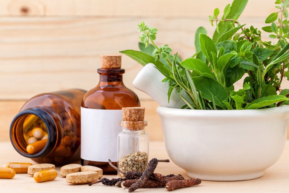 A Mortar And Pestle Filled With Herbs And Pills — Naturopath Australia In Mermaid Beach, QLD