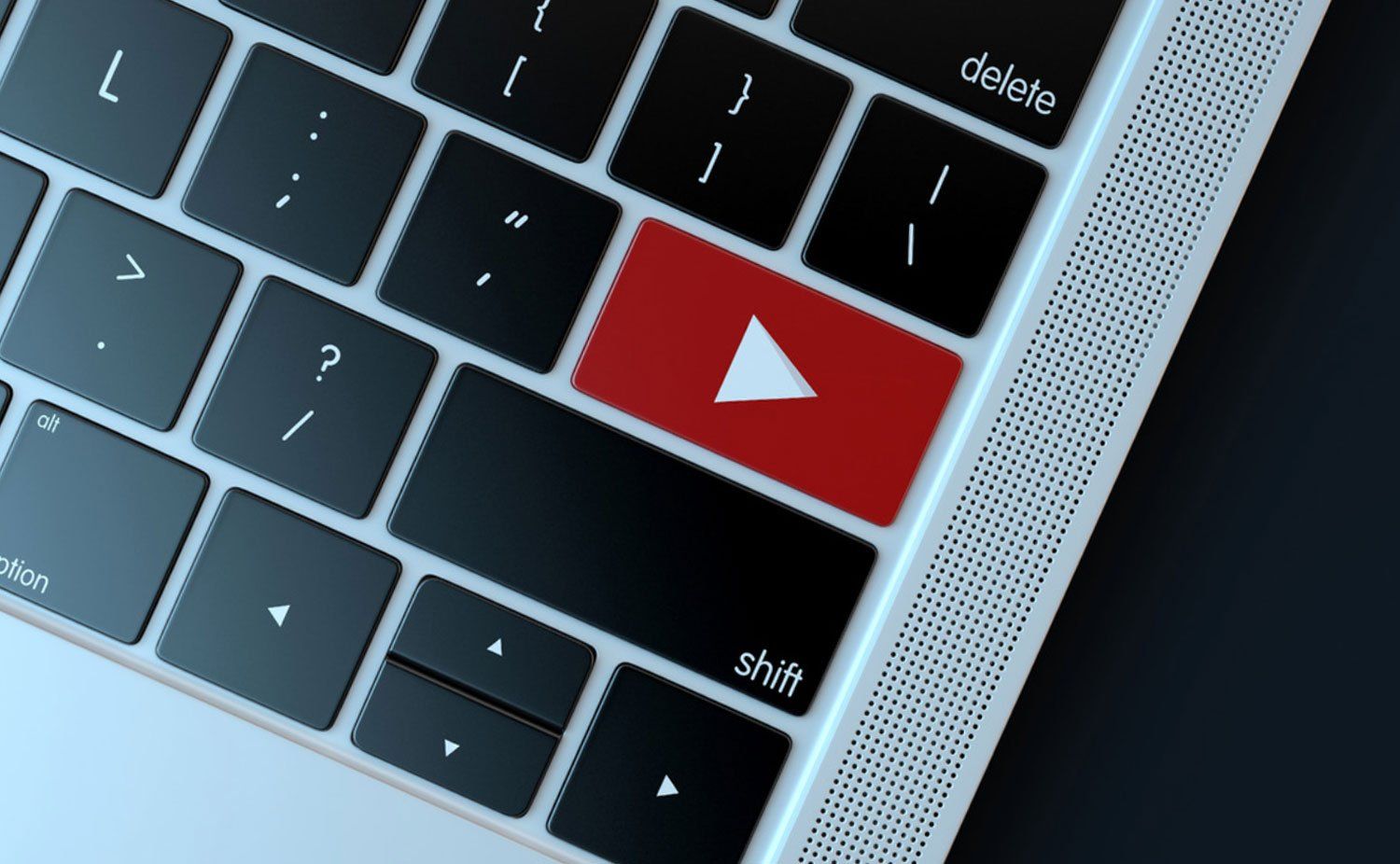 A close up of a keyboard with a red play button