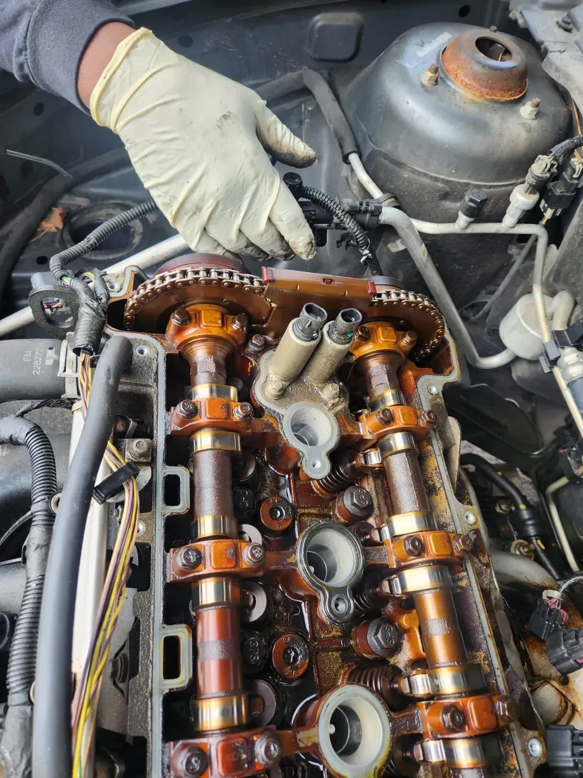 a man repairing with wearing hand gloves | Strike Force Mobile Mechanic llc