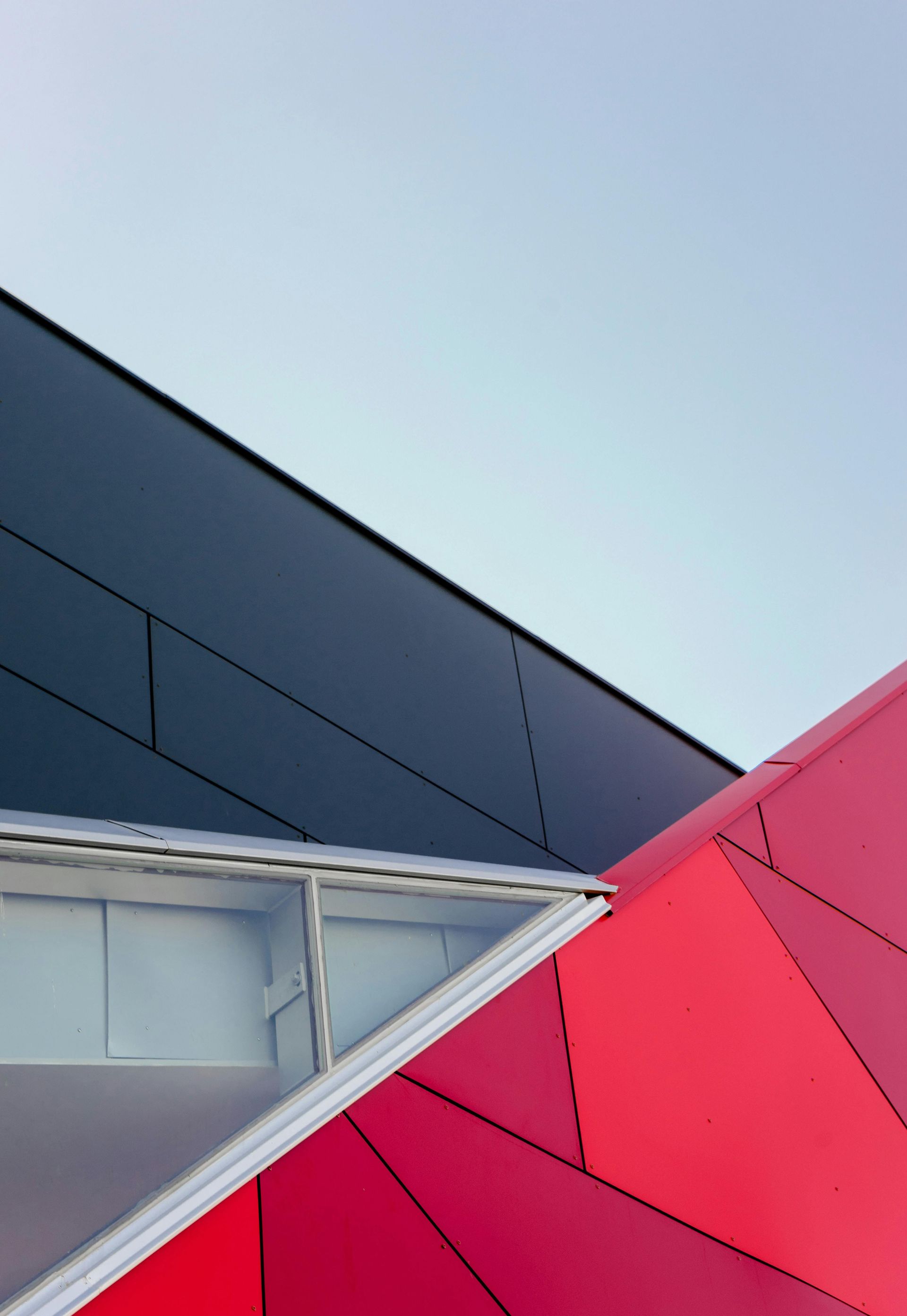 A red and black building with a blue sky in the background