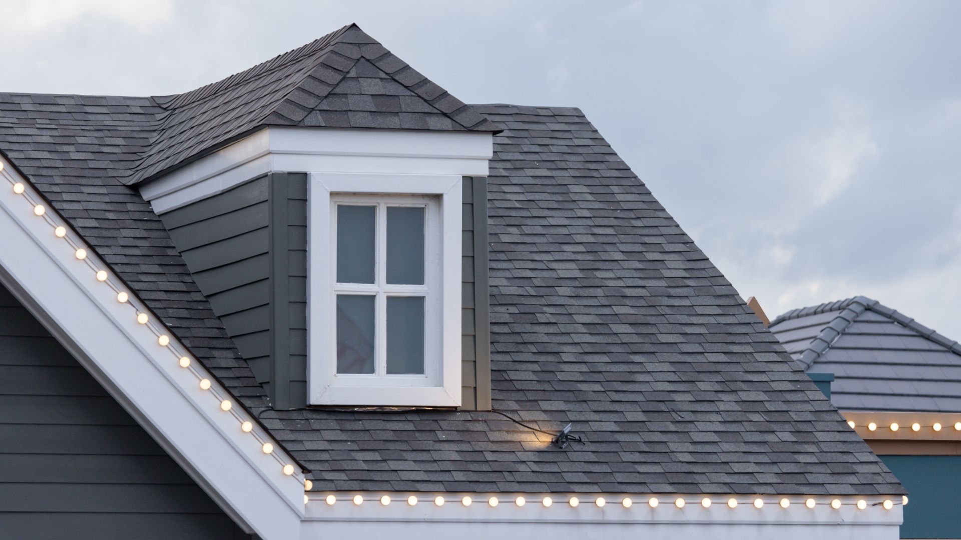 There is a window on the roof of a house.