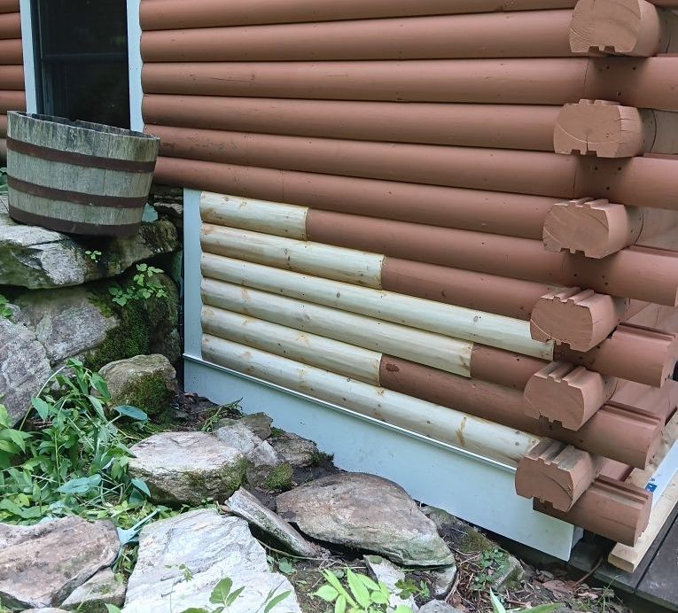 A log cabin with a section of wood repaired