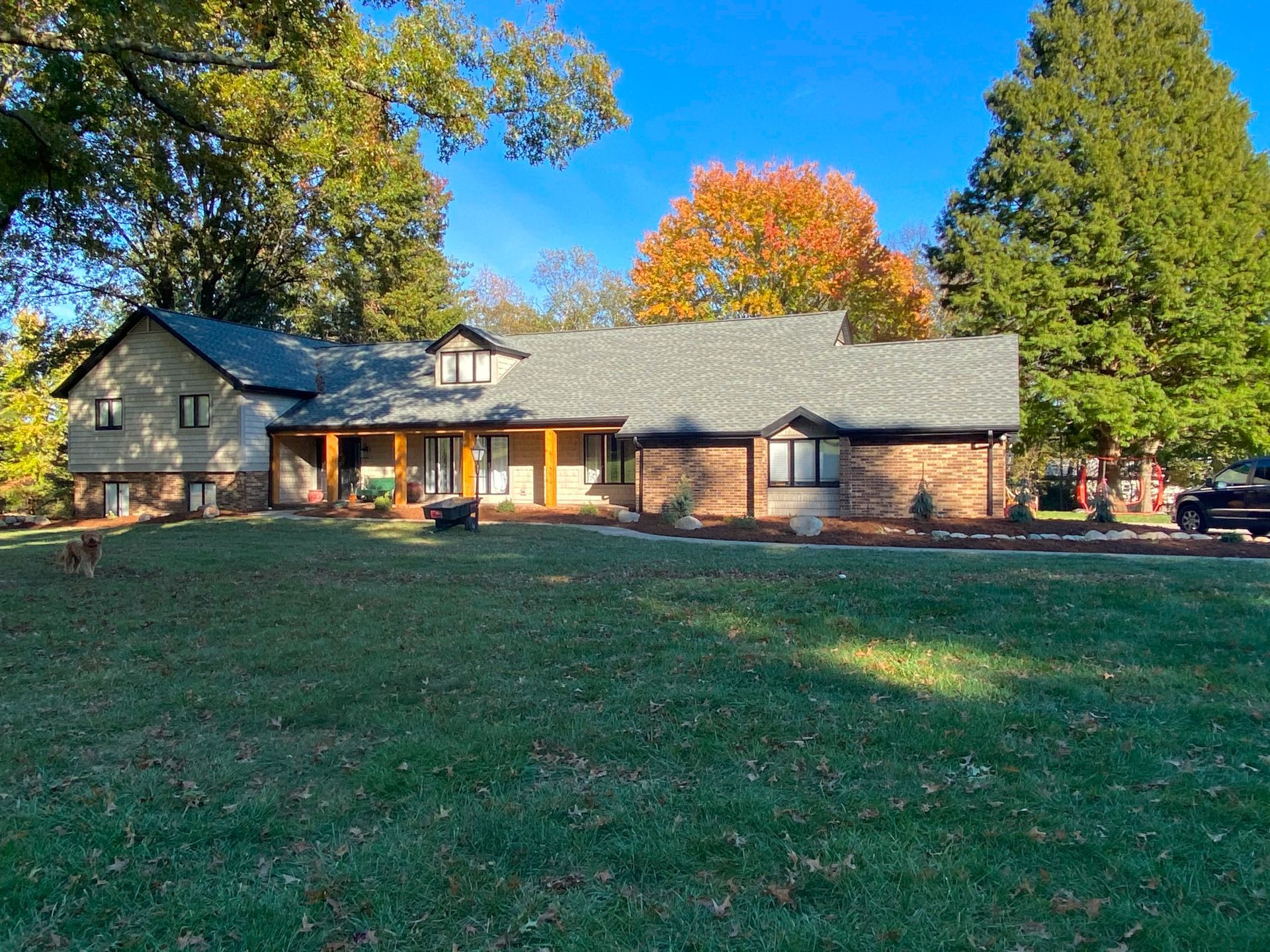 A large house with a large lawn in front of it.