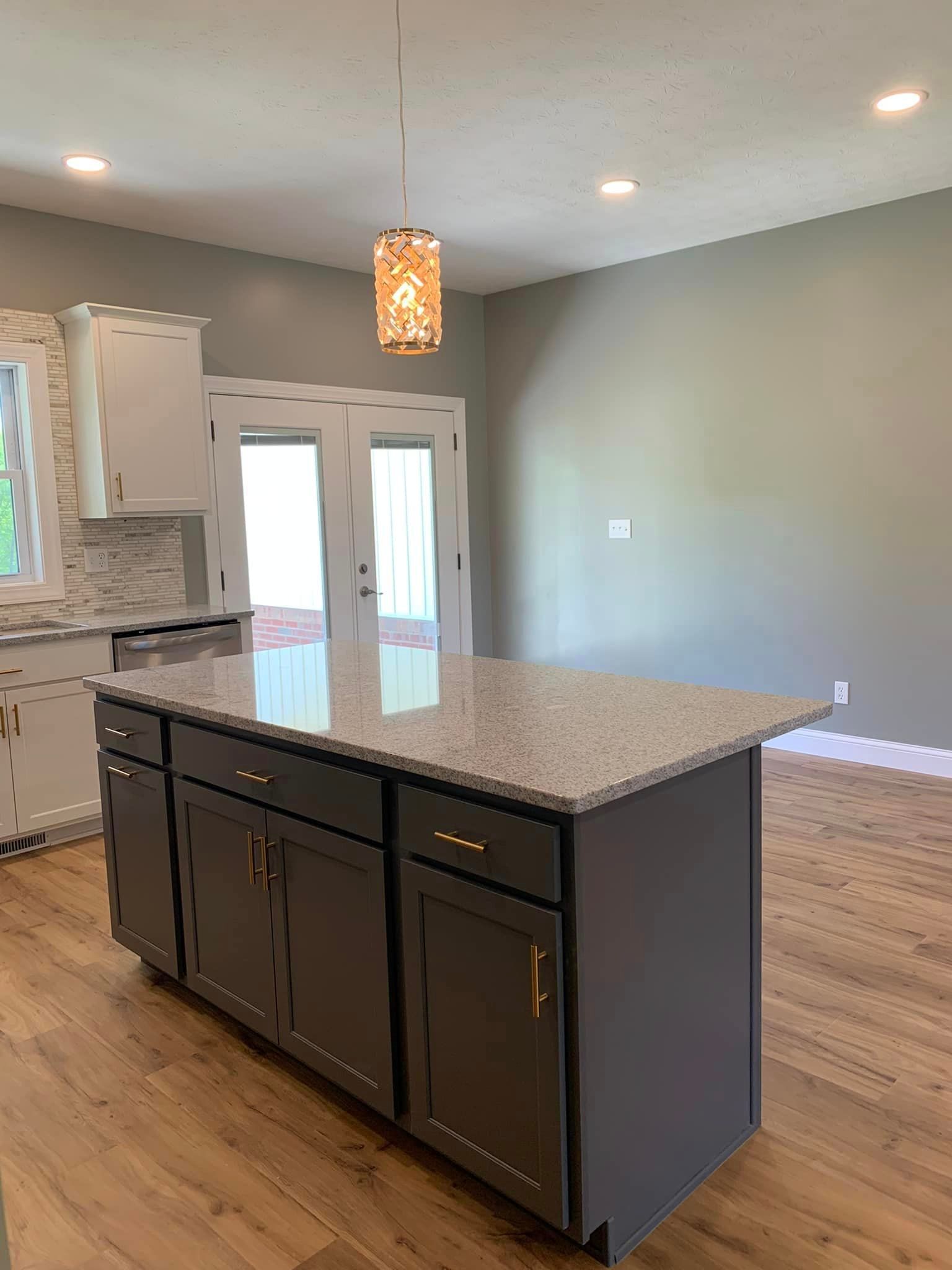 A kitchen with a large island in the middle of the room.