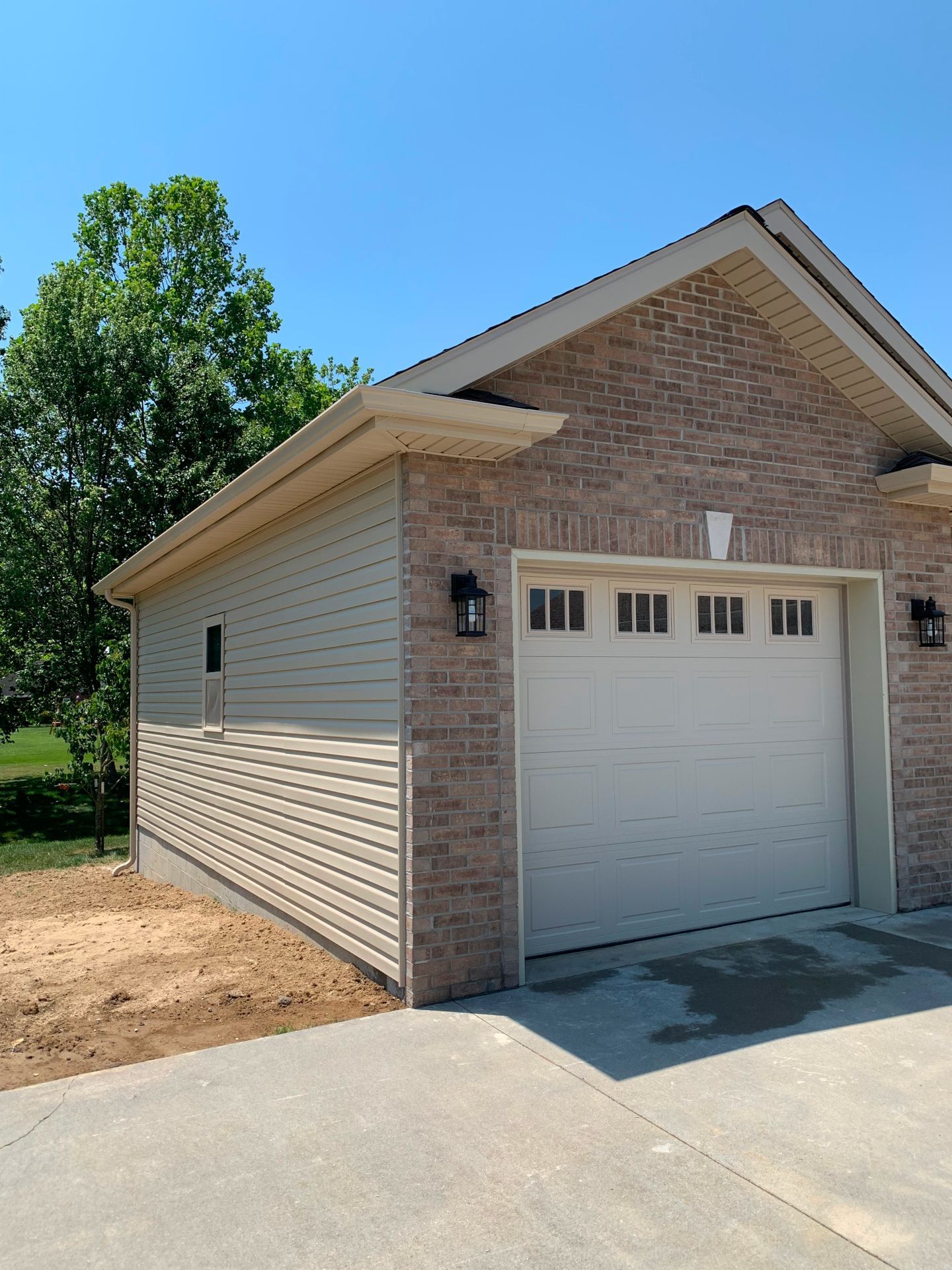 A garage with a white door and a brick wall