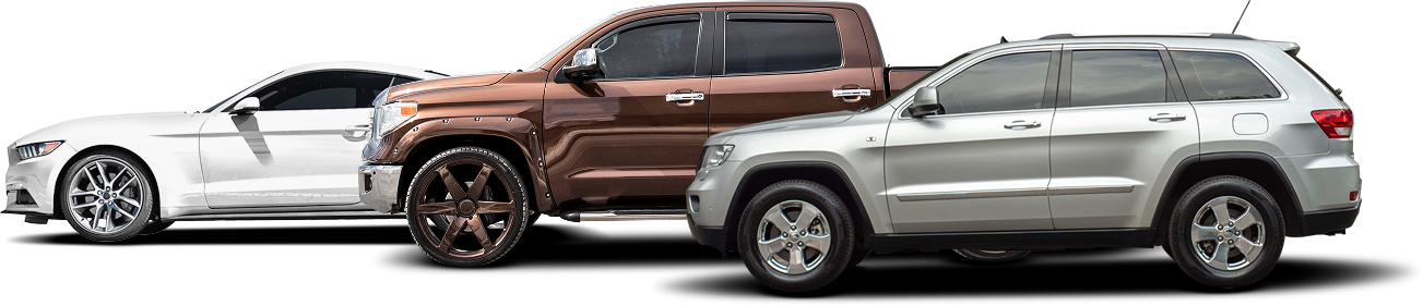 Three vehicles: a white sports car, a brown truck, and a silver SUV.