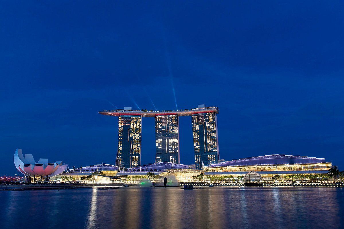The marina bay sands is lit up at night