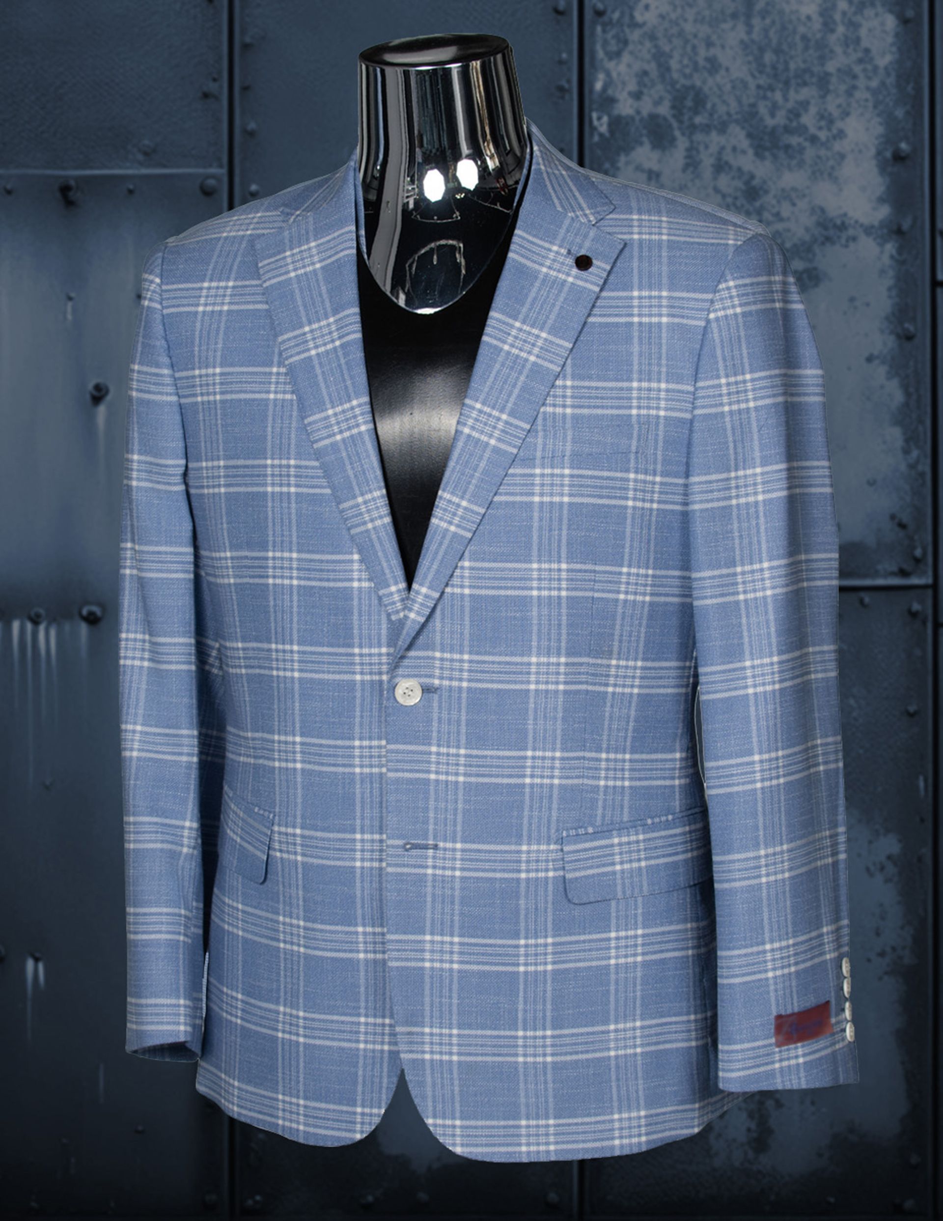 Blue plaid blazer on a black mannequin, single-button closure, dark lapel pin.