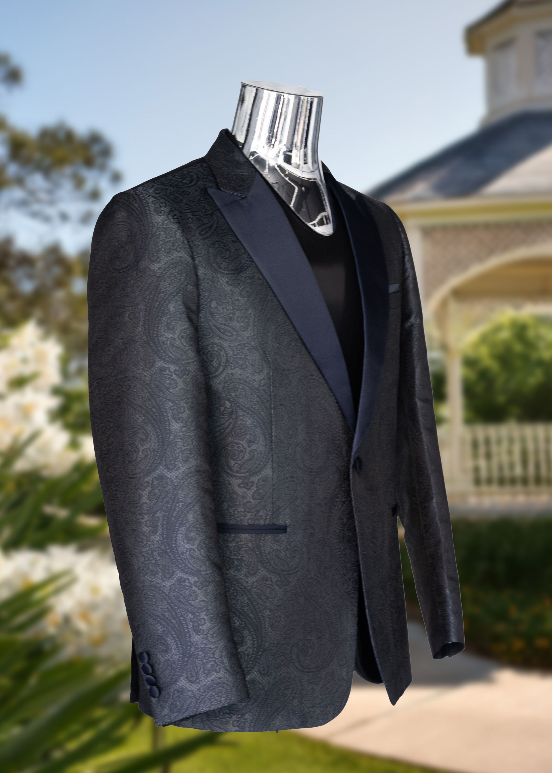 Navy paisley tuxedo jacket on a silver mannequin, outdoors.