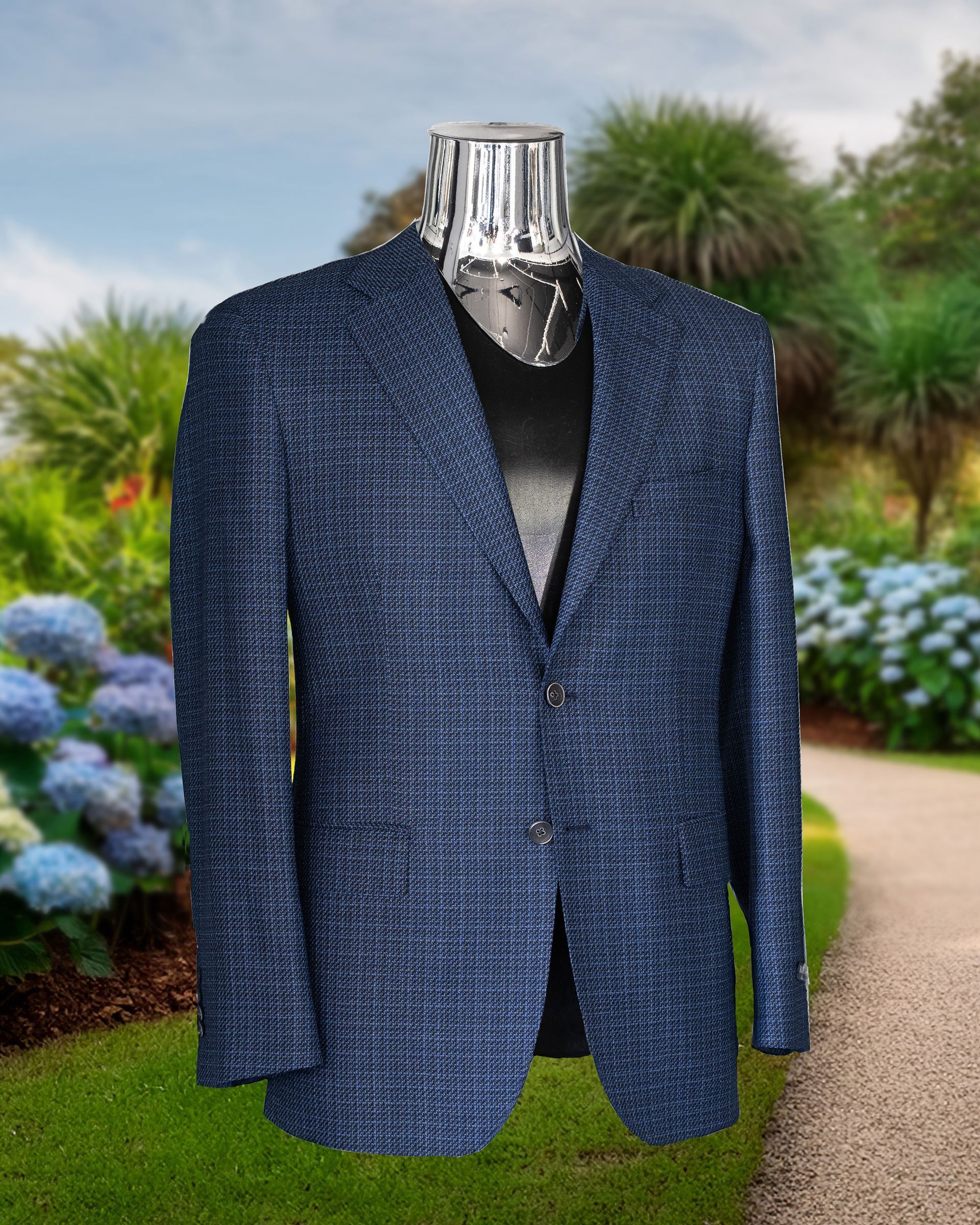 Blue textured blazer on a chrome mannequin against a blurred garden backdrop.