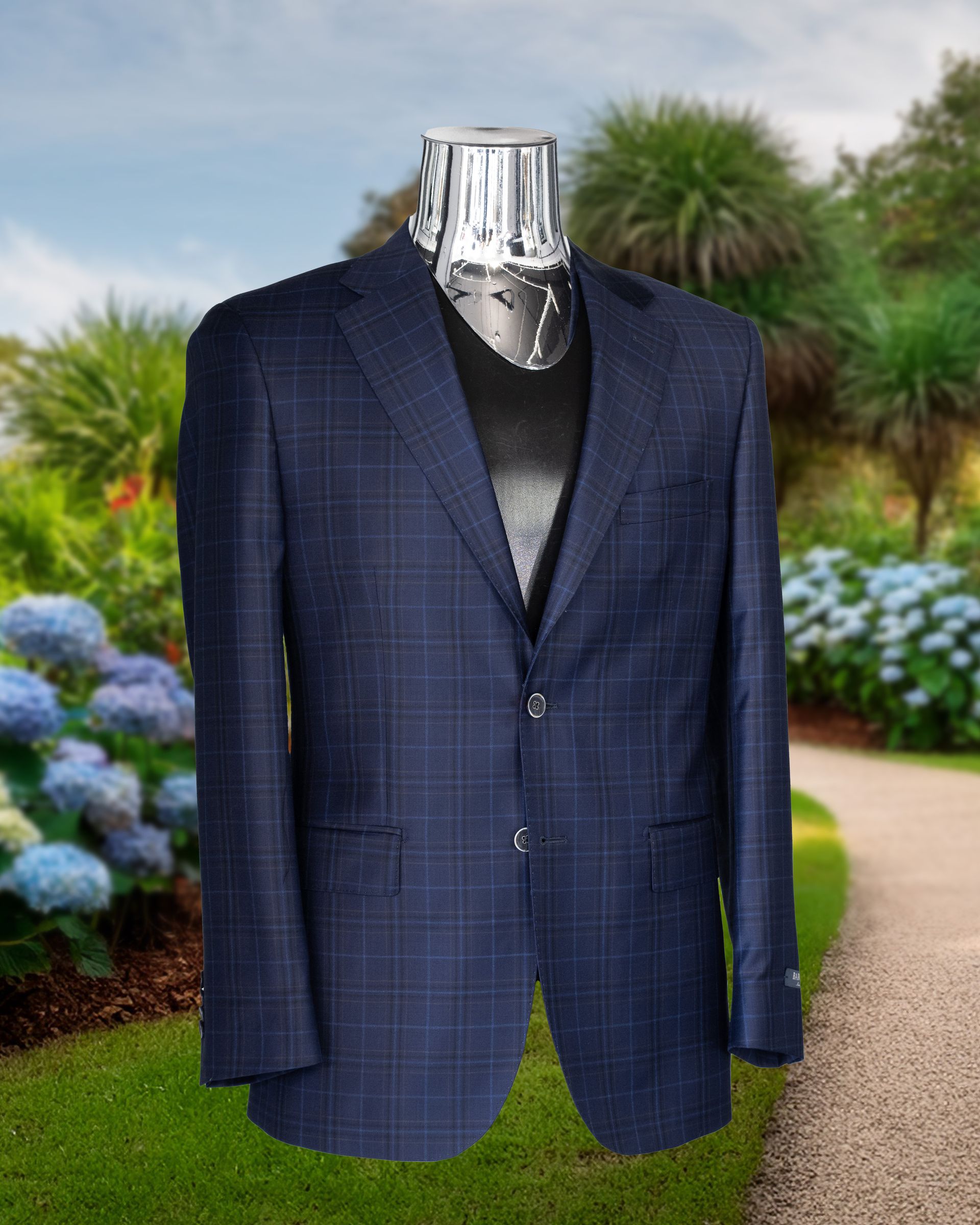 Blue plaid blazer on a chrome mannequin against a blurred outdoor background of green and flowers.