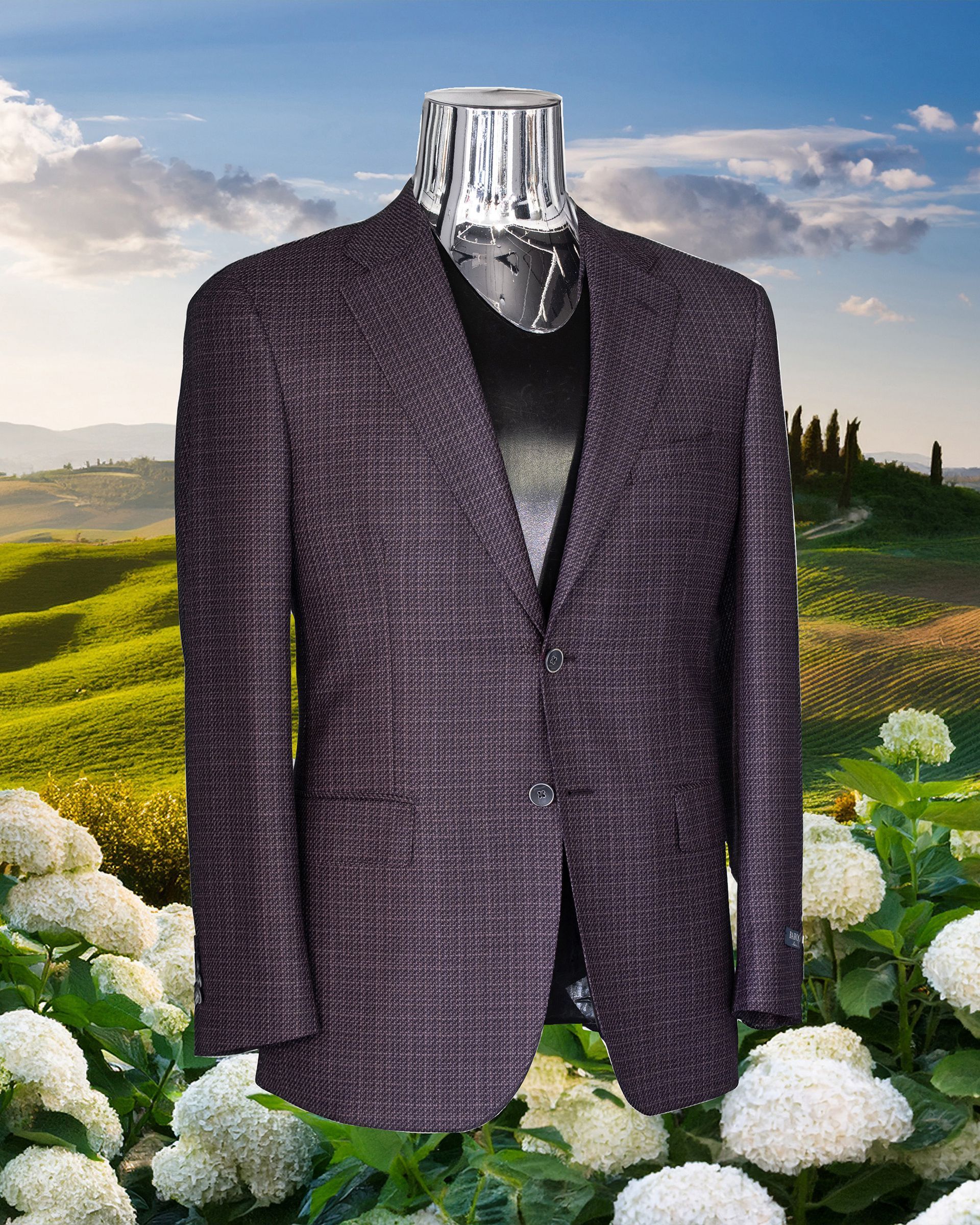 A dark purple textured blazer on a clear mannequin against a Tuscan landscape background.