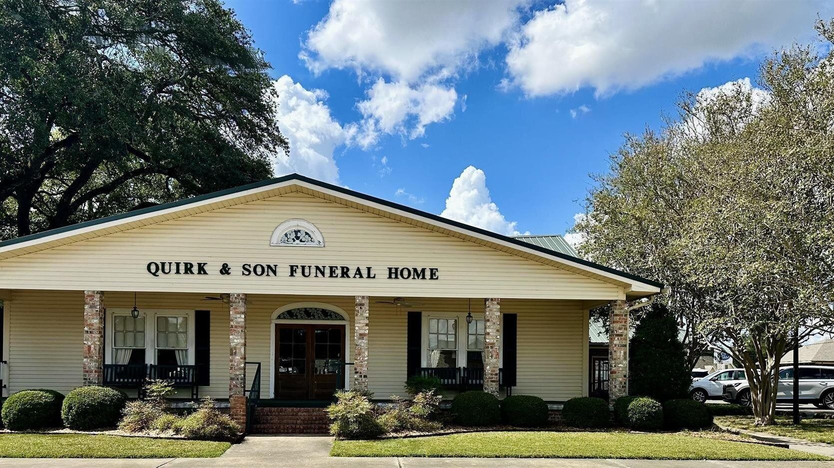 Exterior of Quirk & Son Funeral Home with a blue sky.