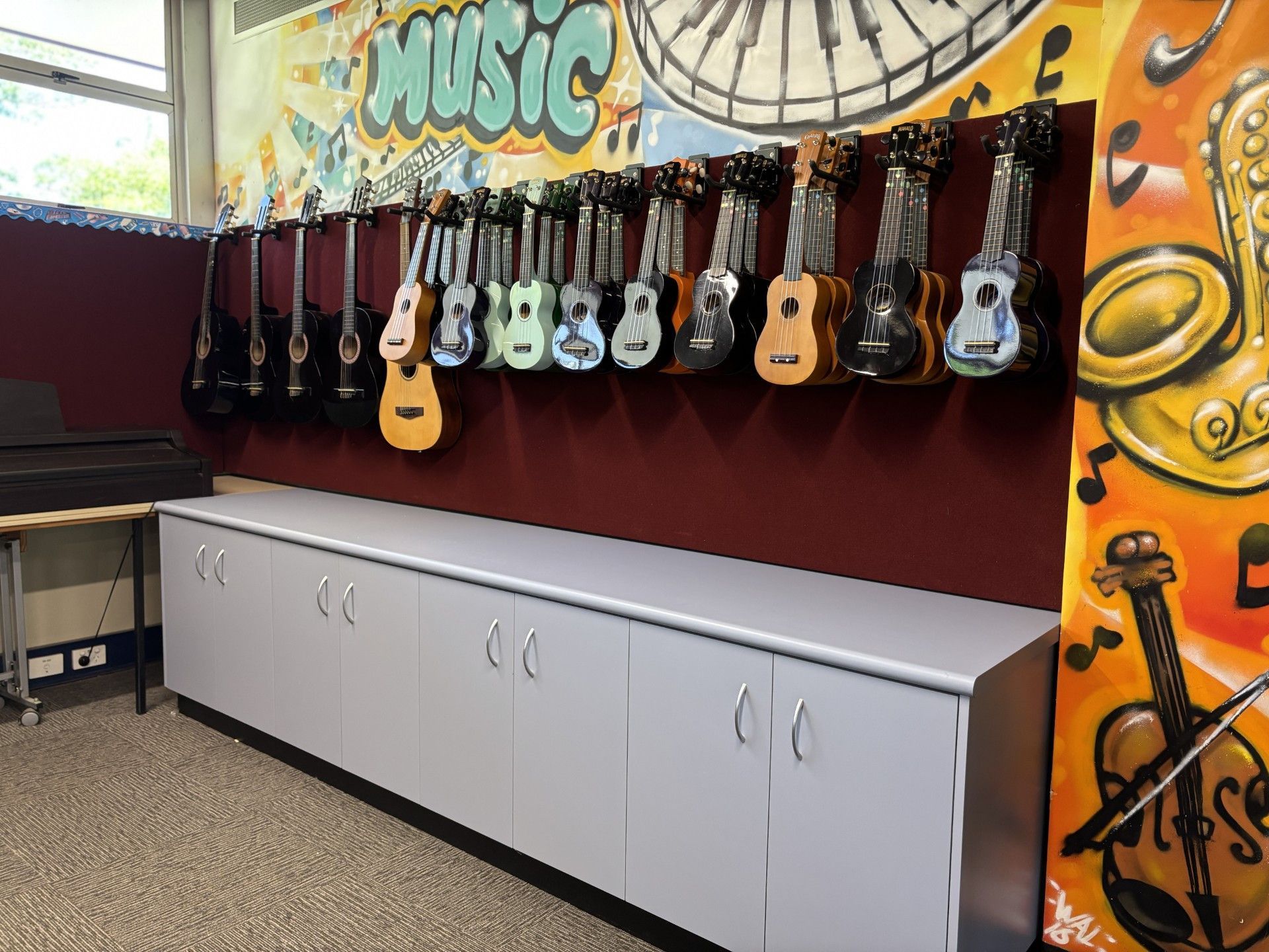 A bunch of guitars are hanging on a wall in a music room — Kitchens by CCJS in Bungalow, QLD
