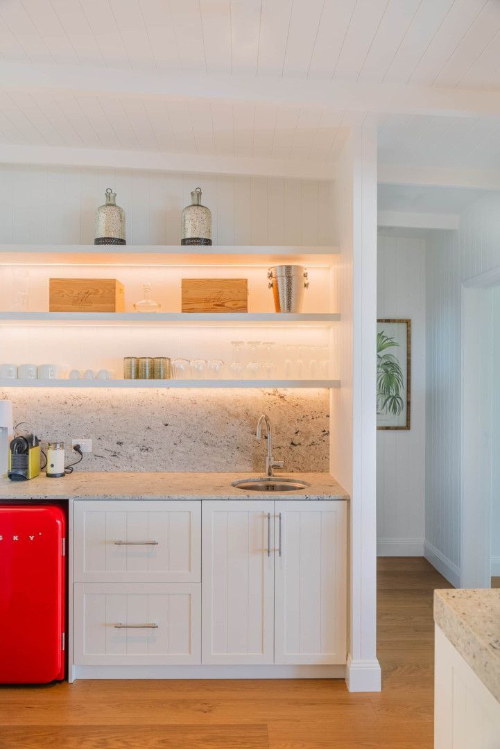 A kitchen with white cabinets and a red refrigerator — Kitchens by CCJS in Bungalow, QLD