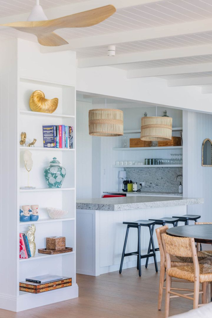 A kitchen with a table and chairs and a ceiling fan — Kitchens by CCJS in Bungalow, QLD