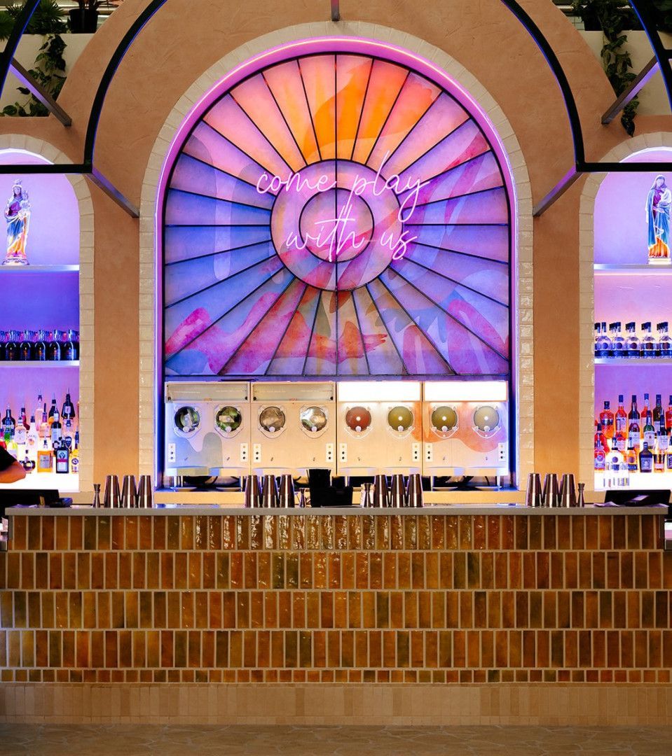 A bar with a large stained glass window behind it — Kitchens by CCJS in Bungalow, QLD
