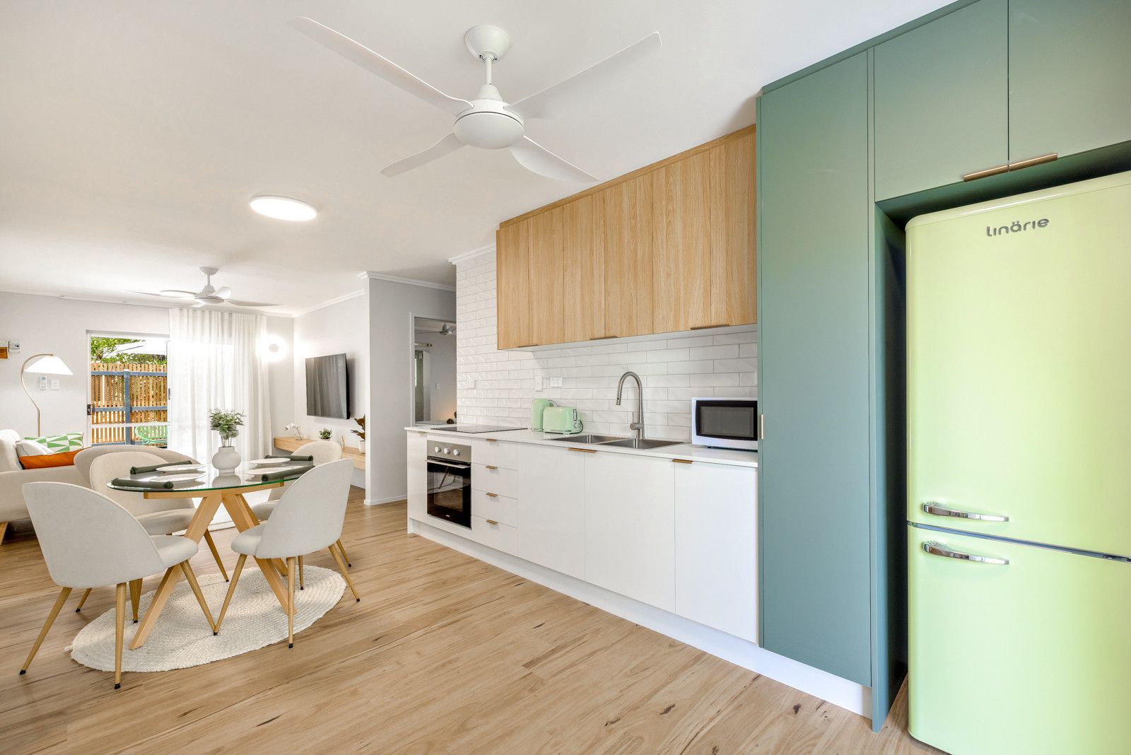 A kitchen with a green refrigerator and a ceiling fan — Kitchens by CCJS in Bungalow, QLD