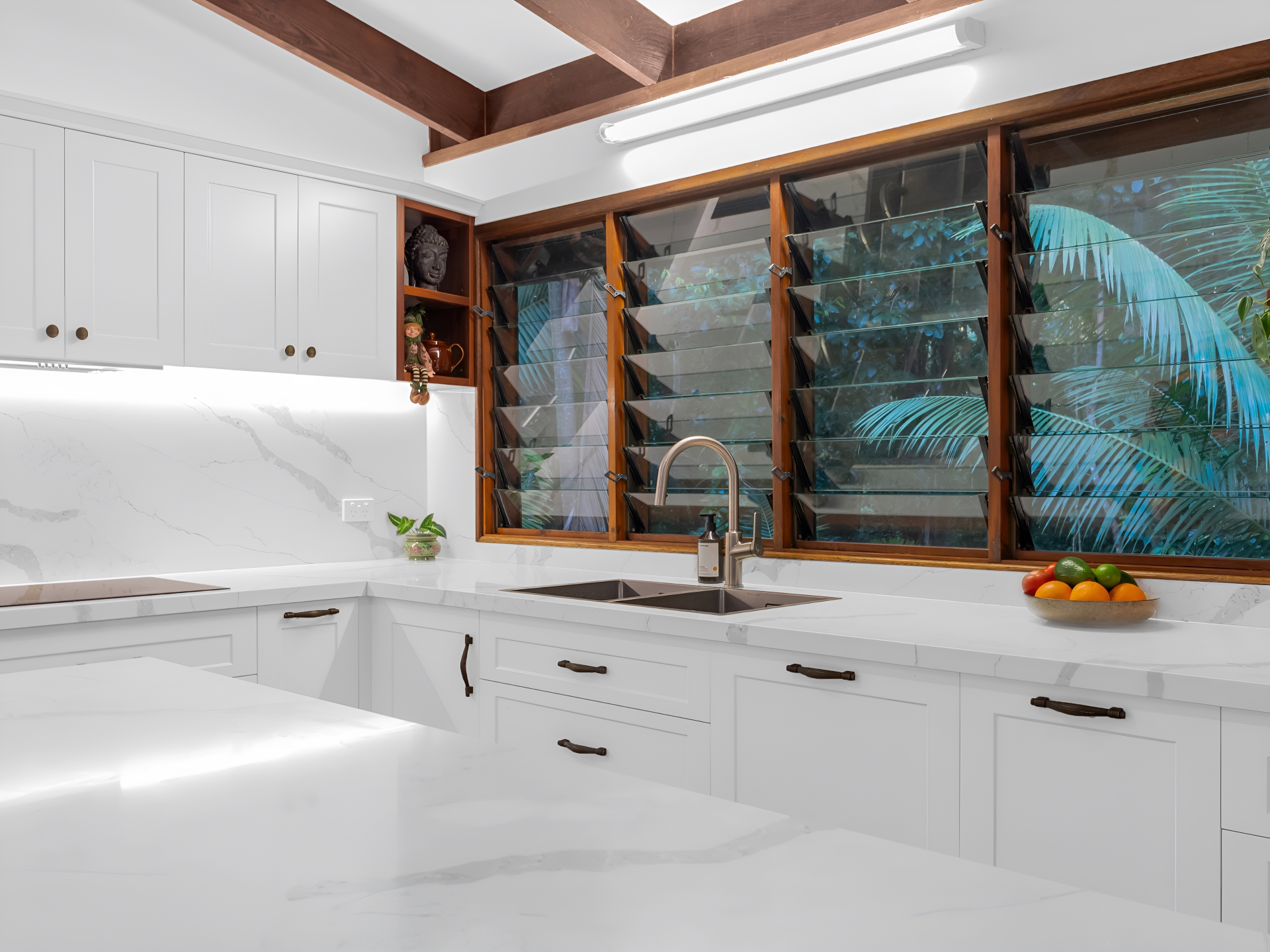 A kitchen with white cabinets , a sink , and a window — Kitchens by CCJS in Bungalow, QLD