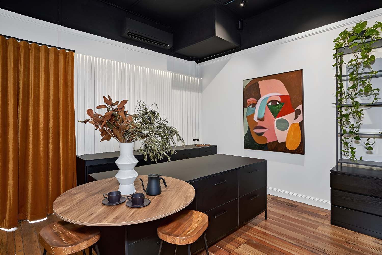 A Kitchen With a Round Table and Stools and a Painting on the Wall — Kitchens by CCJS in Bungalow, QLD