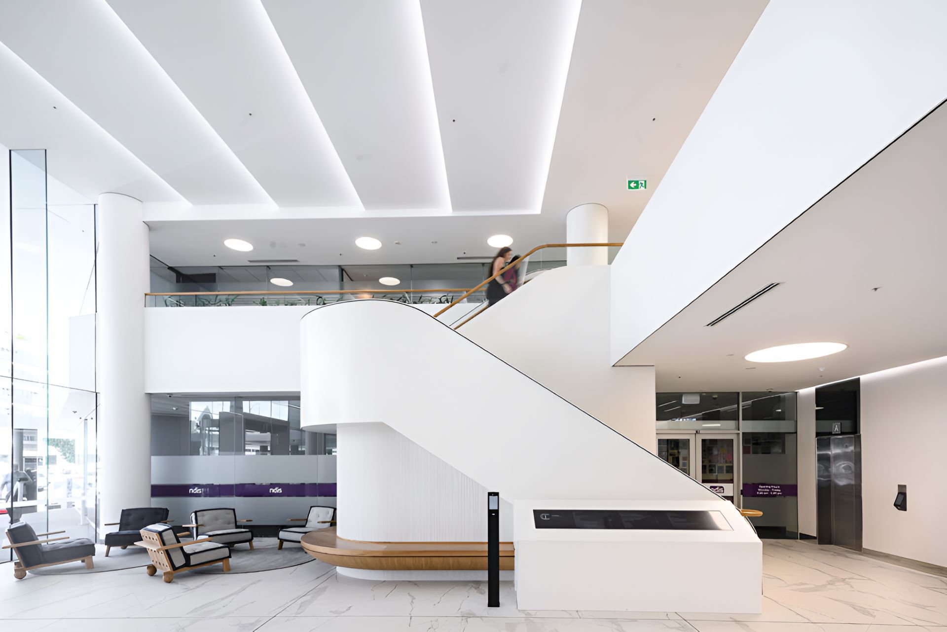A Man is Walking Up a Set of Stairs in a Large Building — Kitchens by CCJS in Bungalow, QLD