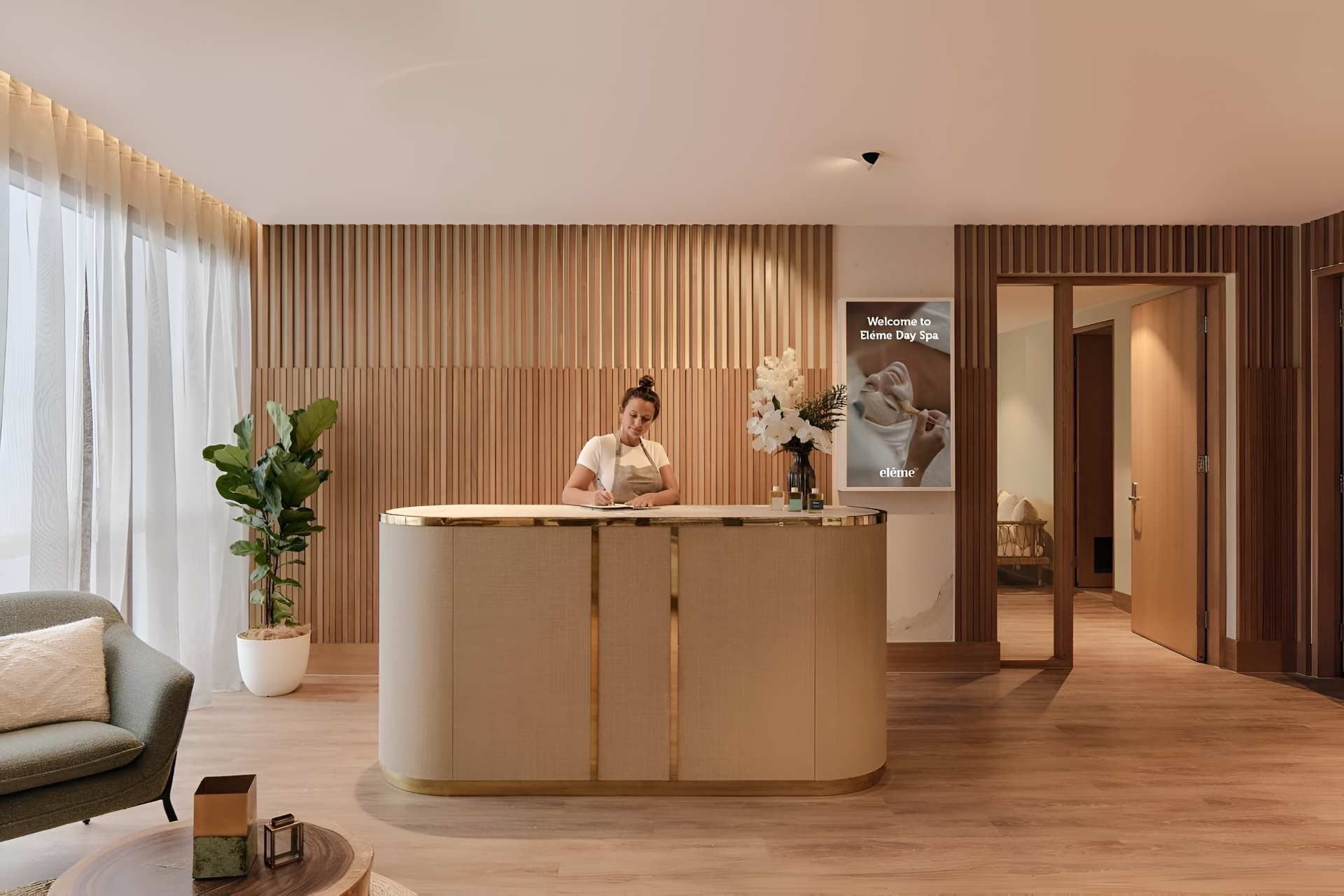 A Woman is Standing at a Reception Desk in a Room — Kitchens by CCJS in Bungalow, QLD
