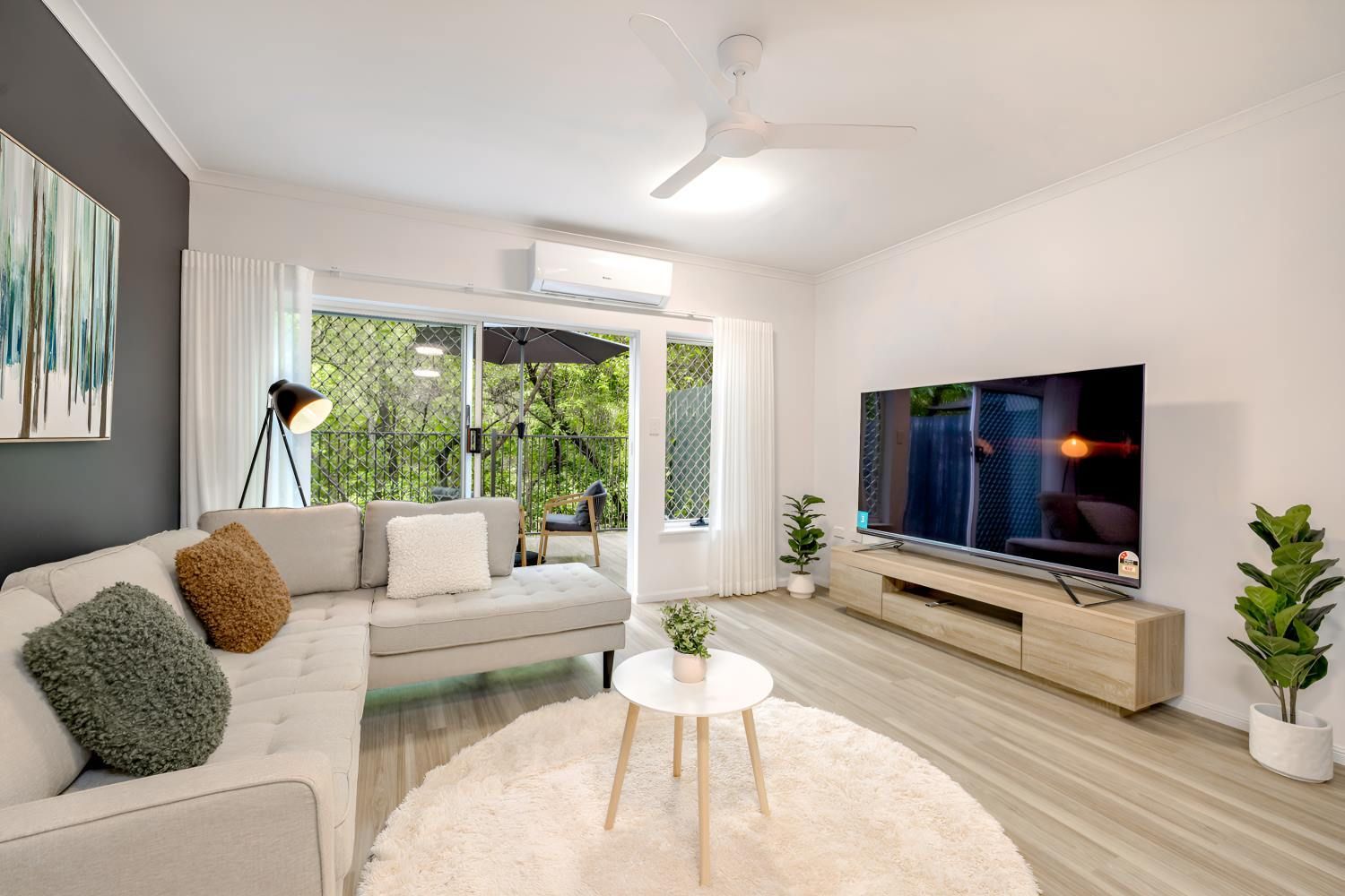 A Living Room With a Couch, Table, Television and a Ceiling Fan — Kitchens by CCJS in Bungalow, QLD
