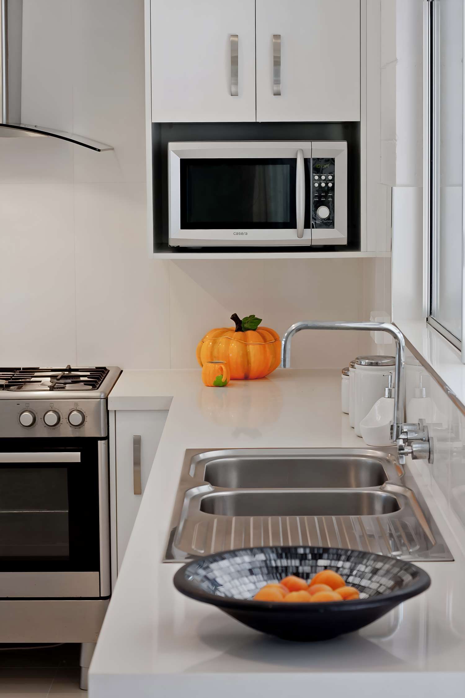A Kitchen With a Stove, Sink, and Microwave — Kitchens by CCJS in Bungalow, QLD