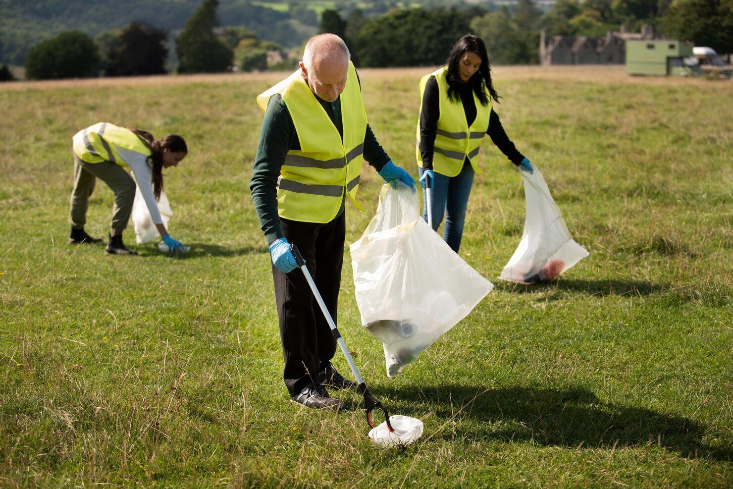 A row of sprayers spraying water on a lush green field.