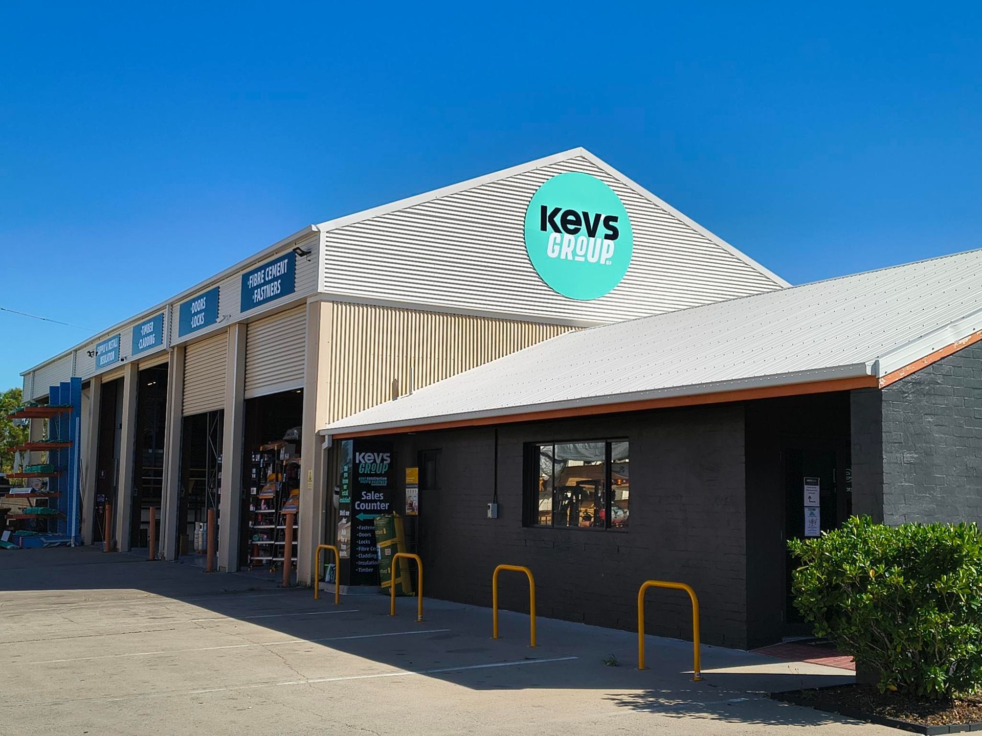 Four Men in Black Shirts and Sunglasses Posing Outdoors — Kev's Group QLD in Kawana, QLD