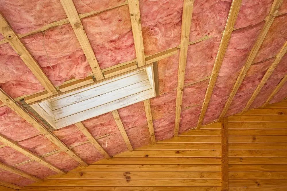 Pink Insulation Between Wooden Rafters in a Sloped Ceiling — Kev's Group QLD in Kawana, QLD