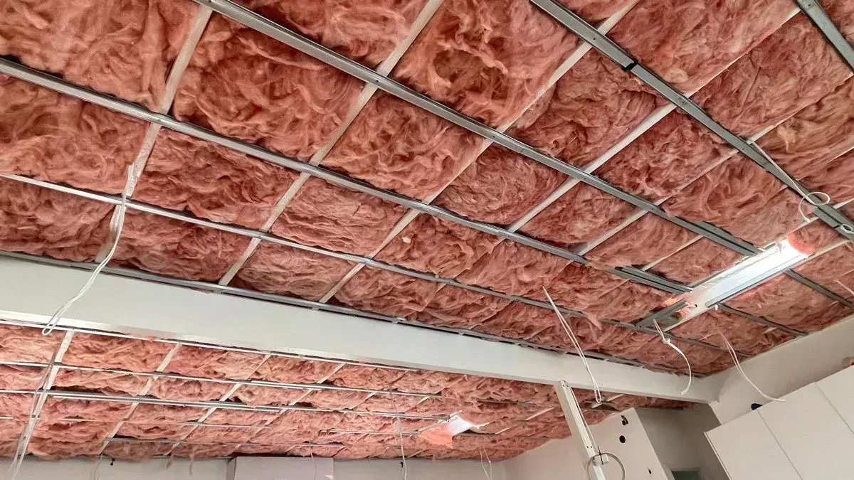 Pink insulation installed above a metal grid ceiling framework — Kev's Group QLD in Kawana, QLD