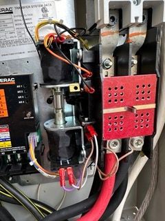 Close-up view of a generator transfer switch wired for automatic power backup system