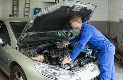 Mechanic Examining Car Engine  —  Auto Repair in Wellsville, PA