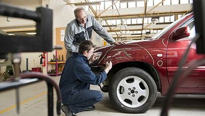 Mechanics Checking Damaged Automobile  —  Auto Repair in Wellsville, PA