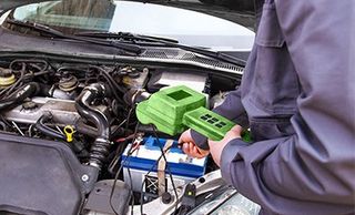 Auto Mechanic Checking Battery — Autor Repair in Wellsville, PA