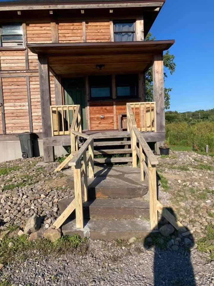 A wooden house with stairs leading up to it