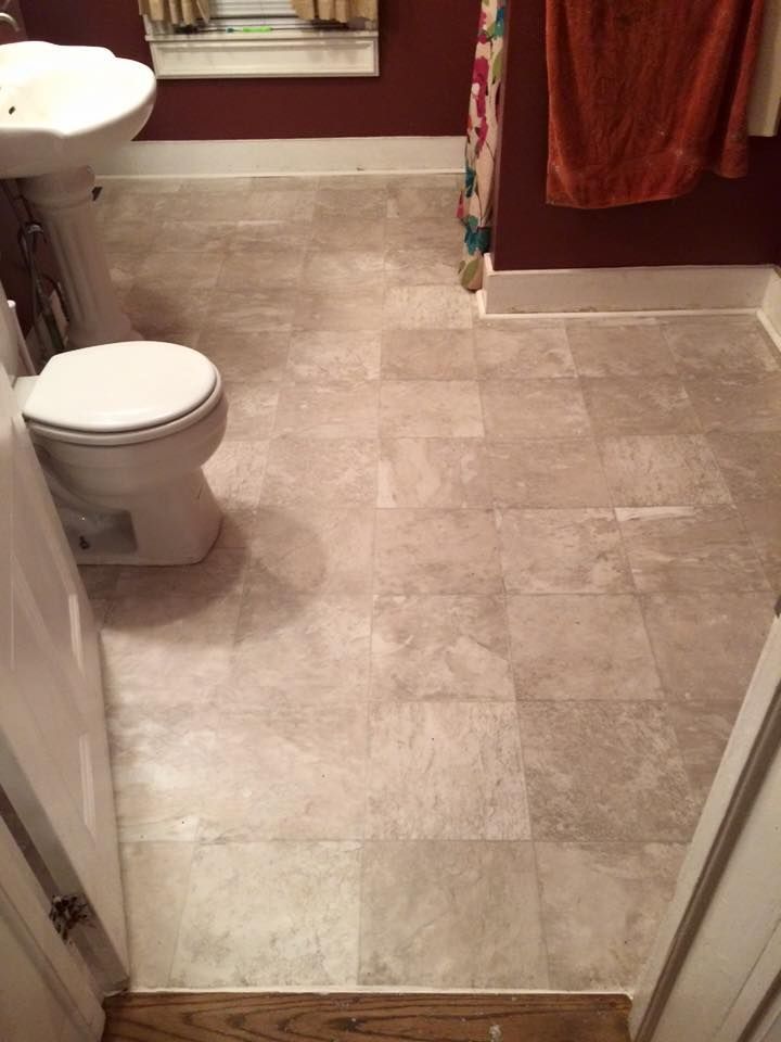 A bathroom with a toilet a sink and a shower curtain