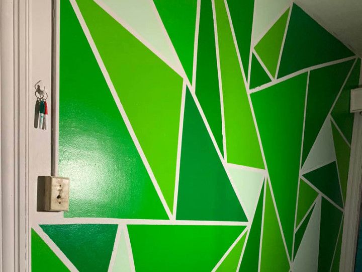 A wall with green and white triangles painted on it