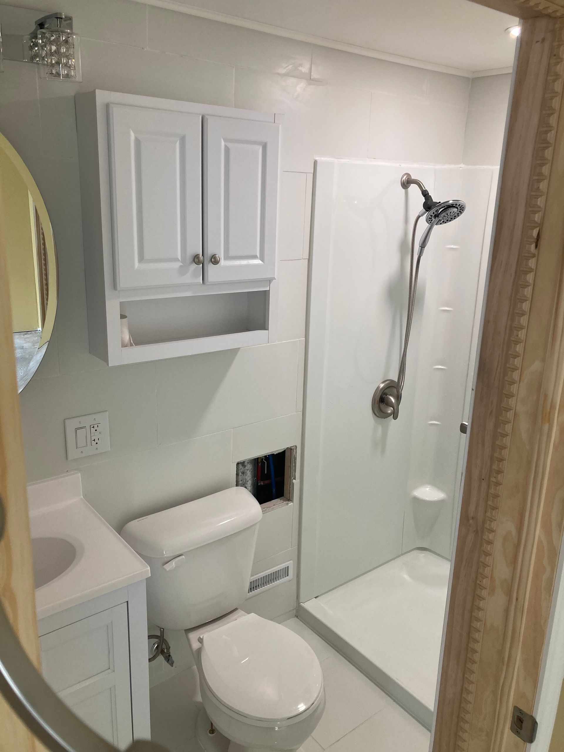 A new white bathroom with a toilet, sink