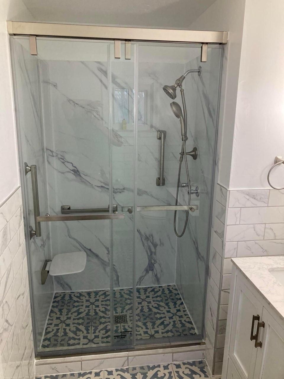 A bathroom with a sliding glass shower door and a toilet